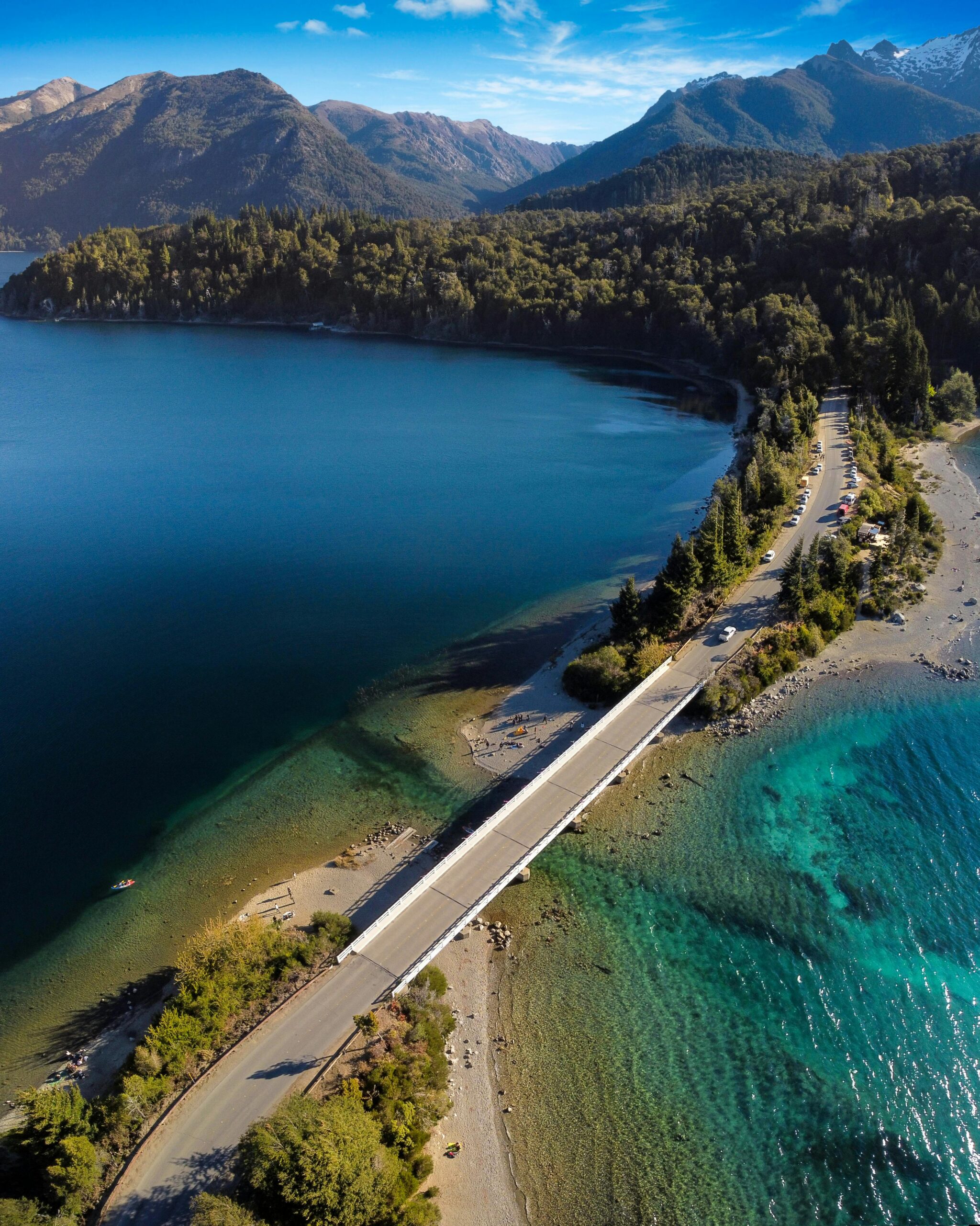 A stunning aerial shot of a picturesque bridge over a lake in Bariloche, Argentina.